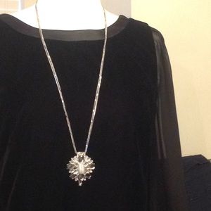 Long crystal pendant on silver colored chain, 32"